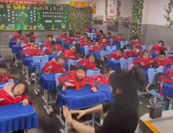 Chinese schoolkids dancing in classroom